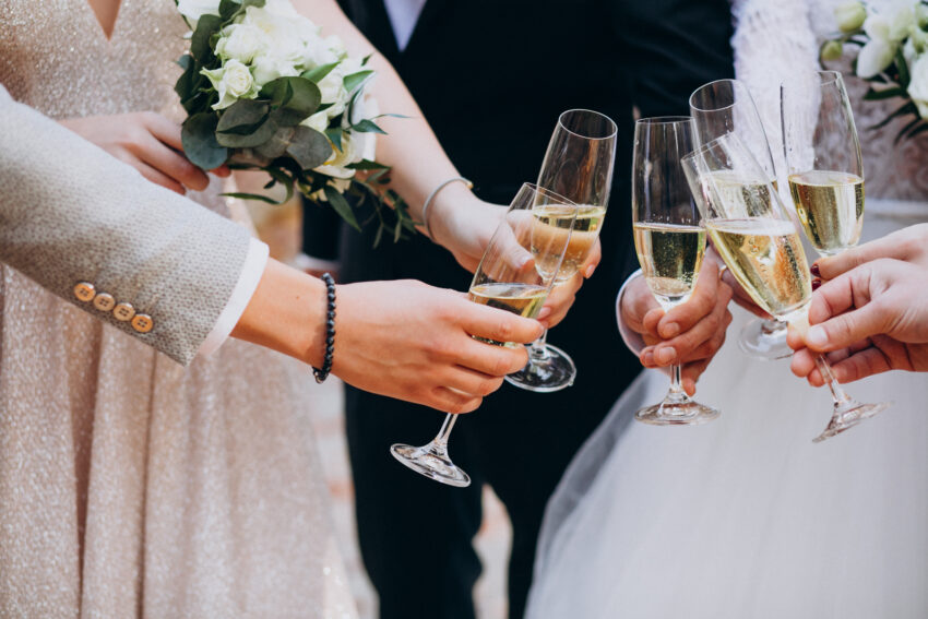 Bride with groom drinking champaigne on their wedding