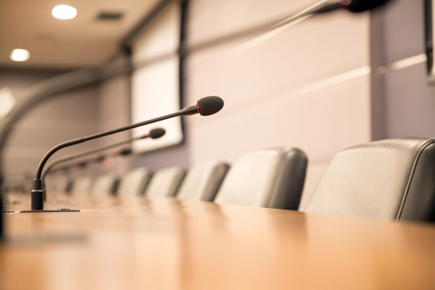 Close up the conference microphone on the meeting table.